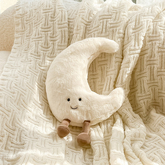 Velvet crescent-shaped pillow with sun and moon and embroidered face